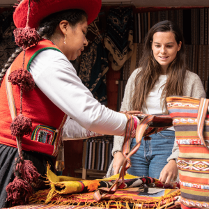 local inca woman shows women the different hand made Embroidery